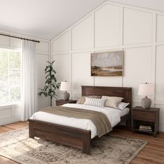 a bedroom with white walls and wood furniture, along with a large rug on the floor