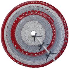 a red and white circular clock with black hands