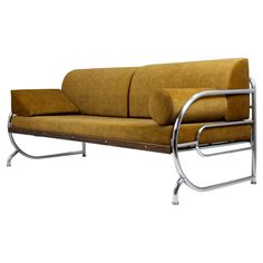 a yellow couch sitting on top of a metal frame