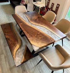 a dining table made out of wood with chairs around it and an area rug on the floor