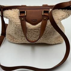 Perfect Ugg Sheep Skin Purse That Is A Rare Find!! She Is A Cozy Find And Would Love To Join Your Collection. She Is Unique, Is Very Generous In Room And Ready To Receive Compliments Whether Your Daily Carrier Or Your Travel Companion To Colder Destinations Carrying All Your Essentials. Ugg Purse, Ugg Purses, Ugg Bag, Ready To Receive, Sheep Skin, Travel Companion, Womens Uggs, Very Rare, Sheep