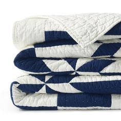 two blue and white quilts stacked on top of each other