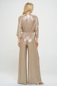 Kimono Sleeve Wide Leg Jumpsuit. Metallic Fabric.Fabric Content: 95% Polyester, 5% Spandex.Made in USA Style: casual, formal Print / Pattern: solid, gold Silhouette: wideleg jumpsuit Fit: regular Neck Line: v neck Sleeve: shortsleeve Lining: no Made In: Made in U.S.A Gold Jumpsuits And Rompers For Summer Party, Gold Jumpsuit And Romper For Summer Party, Gold Stretch Jumpsuit For Night Out, Solid Color Jumpsuits And Rompers For Evening In Fall, Solid Color Strapless Wide Leg Jumpsuit For Party, Glamorous Gold Jumpsuits And Rompers For Party Season, Spring Full-length Jumpsuits For Night Out, Spring Night Out Full-length Jumpsuits And Rompers, Gold Jumpsuits And Rompers For Evening Party Season