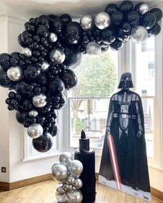 star wars balloon arch with darth vader and silver balloons in front of it