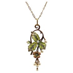 A classic Art Nouveau design, this 15k rose gold necklace features stunning plique-à-jour, Rose Cut diamonds, and beautiful pearls. The centerpiece of the necklace is articulated, hinged in two places so that the flower and pearl drops dangle freely. Three plique-à-jour leaves are translucent—the loveliest matte soft green that fades into subtle purple highlights, clearly done by a master. Each cell of the leaf is filled with plique, with a white metal (platinum or white gold) creating contrast in the center of the leaf. Inside are a channel of bead set Rose Cut diamonds. A flower is suspended from the leaves, with multi-tones of peach to pale yellow that glow against the gold, with a prong-set diamond as its piston. The design work loops over, turning the bail into a scrolling foliate. Th Designer Pendant Sets, Subtle Purple Highlights, Diamond And Pearl Necklace, Design Art Nouveau, Art Nouveau Necklaces, Bijoux Art Nouveau, Art Nouveau Pendant, Purple Highlights, Art Nouveau Design