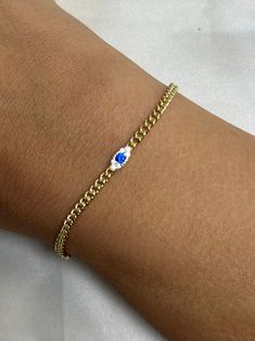 Introducing our small evil eye bracelet, a stunning piece that exudes elegance and charm. This delicate gold bracelet boasts a central ornament showcasing a captivating blue gemstone, encircled by a cluster of dazzling white stones, reminiscent of diamonds. The simplistic design enhances the bracelet's overall allure, making it a must-have accessory for those who appreciate subtle sophistication. -- Material: Solid Sterling Silver, 14k Gold Plated -- Stones: white cubic zirconias -- Color: Silver / Gold -- All of our products are handcrafted ---------------------------------- Merchandise images are enlarged to show detail and may not always be exactly as pictured. Due to the nature of this item being handmade, each piece is unique. Elegant Round Chain Bracelet With Evil Eye, Dainty Blue Round Evil Eye Bracelet, Elegant Round Evil Eye Chain Bracelet, Elegant Evil Eye Chain Bracelet, Dainty Blue Evil Eye Bracelet, Elegant Evil Eye Bracelet With Adjustable Chain, Elegant Beaded Evil Eye Bracelet, Elegant Gold Plated Evil Eye Bracelet, Elegant Evil Eye Bangle Jewelry