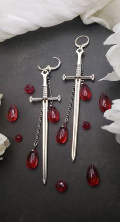 More coming soon! restocking in progress!  These gothic sword earrings add a dark flare to any outfit.  Originally designed and hand made for this shop!  These earrings are on the larger side. Lenght: 4.5in Gothic Piercings Earrings, Blood Drip Earrings, Ren Faire Earrings, Dark Fantasy Jewelry, Romantic Goth Jewelry, Cute Accessories Aesthetic, Evil Jewelry, Alt Earrings, Ornate Earrings