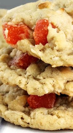 three cookies stacked on top of each other with strawberries in the middle one cookie has been eaten