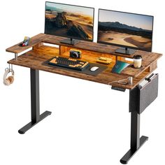 two computer monitors sitting on top of a wooden desk