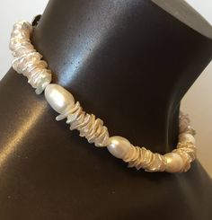 a necklace with pearls on a mannequin