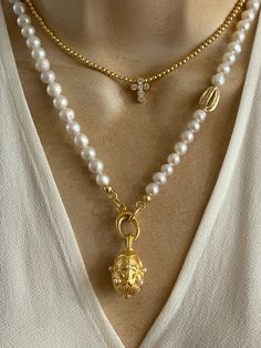 Statement layered necklaces. Sold separately. 1. Pearl necklace features a gold plated pewter Fob pendant with Fleur de Lis and pearl detailing. 7mm freshwater pearls and gold plated  CZ cage bead. Pendant hangs on a lobster clasp and is removable. Approximately 18 inches. 2. Cross necklace features 2mm gold filled beads and gold plated brass Cross. Adjustable length 16-18 inches.  🎁All orders are shipped in a gift box. Gold Double Strand Spiritual Necklaces, Spiritual Pearl Drop Necklace With Round Beads, Gold Double Strand Pearl Necklaces, Gold Double Strand Beaded Necklace With Pearl Chain, Gold Double Strand Pearl Chain Beaded Necklace, Gold Double Strand Pearl Chain Necklace, Double Strand Pearl Chain Beaded Necklace In Gold, Spiritual Necklace With Pearl Pendant And Round Beads, Handmade Gold Necklaces For Layering