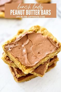 peanut butter bars stacked on top of each other with chocolate frosting in the middle