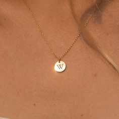 "Our tiny circle initial necklace is a fun choice when you want to make a simple, discreet statement of any single letter, number, or character that you feel defines you the best. Made of 14K gold-filled, the shiny finish disc comes on a dainty and delicate chain, giving you a truly minimalist look. Free Engraving for a limited time! NECKLACE DETAILS ⚬ 14k gold-filled disk (s) and chain. ⚬ Disc measures 10mm (.39\"). ⚬ Chain in your choice of 16\", 18\" or 20\" length ⚬ Personalized engraving of Minimalist 14k Rose Gold Initial Necklace, Simple Round Pendant Charm Necklace For Anniversary, Simple Tiny Initial Pendant Charm Necklaces, Simple Tiny Initial Pendant Charm Necklace, Simple Tiny Initial Pendant Jewelry, Minimalist Round Disc Initial Necklace As Gift, Minimalist Round Disc Initial Necklace For Gift, Minimalist Yellow Gold Initial Necklace For Personalized Gift, Minimalist Gold Name Necklace