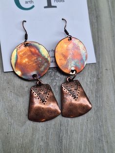 These boho style earrings are designed from copper circles 1" in diameter that have been fire painted using a propane torch to bring out the different colors in the metal. NOTE:  Certain lighting will bring the colors out  more than other types of lighting. (See photos) They are finished with copper bell-shaped dangles. The earrings measure just over 2.5" in length.  They will ship in a gift box or bag via USPS with tracking info provided. Artisan Hand Painted Metal Jewelry, Copper Drop Earrings For Festival, Copper Round Jewelry For Festivals, Round Copper Jewelry For Festivals, Nickel Free Artsy Jewelry For Festivals, Copper Drop Earrings For Festivals, Artistic Brown Jewelry For Festival, Hand Painted Artsy Jewelry For Festivals, Artistic Copper Jewelry