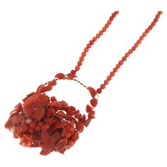 Introducing an exceptional necklace, a work of art that combines the elegance of gold with the charm of natural coral. Masterfully crafted, this necklace features a chain of raised coral, supported by elements in 18 karat and 9 karat gold that enhance its vibrant color and natural beauty. The centerpiece of this creation is the intricate bouquet of finely carved coral flowers, each placed with precision to create a striking visual effect. The clasp of the necklace is designed to be both elegant Coral Red Coral Necklace For Gifts, Coral Red Coral Necklace Gift, Red Coral Pendant Necklace, Handmade Elegant Red Coral Necklace, Elegant Single Strand Red Coral Necklaces, Elegant Handmade Red Coral Necklaces, Elegant Single Strand Red Coral Necklace, Elegant Coral Necklaces With Gemstone Beads, Unique Red Coral Necklace For Gifts