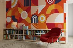 an orange chair sitting in front of a book shelf