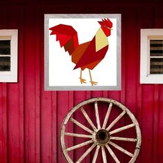 a red barn with an old wagon wheel in front of it and a painting of a rooster on the wall