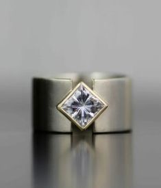 a diamond ring sitting on top of a table