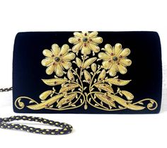 "Luxury black velvet evening clutch bag, expertly hand embroidered with gold flowers and embellished with genuine semi precious stones, to create an opulent, sophisticated 3D effect. Add an eye-catching pop of color, texture and sparkly bling to your overall party look. It is just the right size to hold your essentials for the night - phone, credit cards, money, keys and lipstick. The shoulder strap keeps your hands free for carrying a drink or holding a plate of food. Or twist the shoulder stra Holding A Plate, Statement Clutch Bag, Plate Of Food, Unique Handbags, Embroidered Handbag, Velvet Clutch, Floral Clutches, Wedding Clutch, Purse Gift