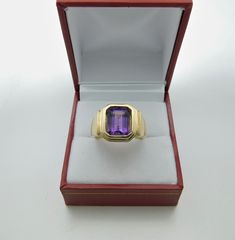 Gemstone: Amethyst Treatments: None Specifications: 10x8mm, 3.05 carats Color: As shown. Clarity: Transparent, no visible inclusions Cut: Emerald cut Origin: Brazil This is a stunning amethyst. Please note: these rings are made to order, so you will notice that all the center stones are shown positioned on the ring mounting. This is a fine and classy example of what a bold masculine ring should look like. Perfect for a man, yet not too masculine that a woman could not get away with wearing it. T Formal Amethyst Ring In 14k Gold, Emerald Cut Amethyst Ring For Formal Occasions, Formal 14k Gold Amethyst Gemstone Ring, Classic Yellow Gold Amethyst Gemstone, Classic Yellow Gold Rectangular Amethyst Ring, Rectangular Amethyst Ring In Yellow Gold, Yellow Gold Amethyst Ring With Rectangular Shape, 14k Yellow Gold Emerald-cut Amethyst Ring, Formal 14k Gold Amethyst Ring With Center Stone