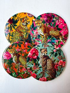 three coasters decorated with leopards and flowers