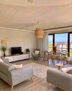 a living room filled with furniture and a flat screen tv