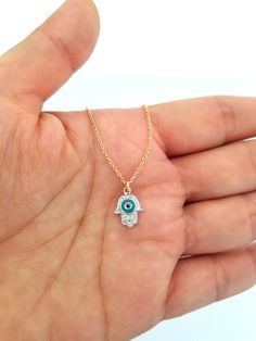 This Diamond and Turquoise Evil Eye Hamsa Charm features closed ring, you use it alone as a charm, or combine it with other charm to complete your necklace or bracelet. Chain doesn't include Style: Diamond Hamsa Charm Size approx. 12mm Stone type: Diamond Number of diamond: 16 pieces Total carat weight: 0.06ct Material: 14K Gold Color: Yellow, White, Rose (Choose From Drop Box) Country of origin: United States Finished: High Quality Sold by piece Please Check Out Our Chain https://www.etsy.com/l Adjustable Turquoise 14k Gold Jewelry, Adjustable 14k Gold Turquoise Jewelry, Yellow Gold Evil Eye Jewelry For Good Luck, Spiritual Yellow Gold Jewelry With Lobster Clasp, Turquoise Charm Necklace With Lobster Clasp As Gift, Blue Gold Plated Jewelry With Charms, Fine Jewelry Pendant For Good Luck, Fine Jewelry In 14k Gold With Turquoise, Dainty Turquoise Gold-plated Jewelry