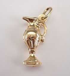 Vintage 14K Yellow Gold Pitcher Carafe Charm Pendant. This antique charm is 14K Yellow gold and weighs 1.7 grams. This charm measures 21 mm in height without the bail and 10 mm in width.  I will ship this pendant promptly in a gift pouch. Elegant Hallmarked Charms For Collectors, Elegant 14k Gold Charms For Collectors, Elegant 14k Gold Collectible Charms, Elegant Gold Charms For Formal Occasions, Engraved Yellow Gold Charms For Collectors, Classic Gold Charms For Anniversary, Antique Gold Hallmarked Charms, Antique 14k Gold Hallmarked Charms, Antique Hallmarked 14k Gold Charms