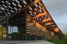 a large building with wooden slats on it's side and stairs leading up to the entrance