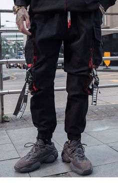 Men can sport a bold look by wearing these cargo pants. These full-length hip-hop pants are crafted from soft cotton. The harajuku joggers’ pants come with ingenious tactical zipper pockets that provide security. The streetwear is available in multiple sizes and comes in black color along with elastic mid-waist closure.

Specifications
Brand Name: GeraldBlack
Pant Style: Cargo Pants
Length: Full Length
Front Style: Flat
Fit Type: REGULAR
Material: COTTON
Thickness: Midweight
Fabric Type: Broadcl Harajuku Style Black Pants With Pockets, Harajuku Black Pants With Pockets, Harajuku Style Streetwear Cotton Pants, Harajuku Style Cotton Pants For Streetwear, Baggy Harajuku Style Cargo Pants, Harajuku Style Baggy Cargo Pants With Pockets, Baggy Techwear Sweatpants, Baggy Techwear Sweatpants For Streetwear, Techwear Baggy Sweatpants For Streetwear