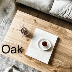 a wooden table with a cup of coffee on it and the word oak written in black