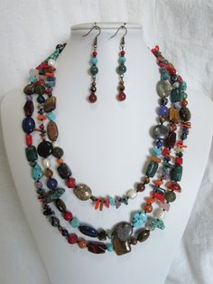 This multi gemstones necklace set is made so that each one is unique. Because all the beads vary in color, shape and size, and it is a random design, each necklace will be slightly different from the picture. I have tried to duplicate the earrings as closely as possible. This is a multi-colored celebration of gemstones from around the world. The necklace is 65 inches long and the earrings dangle 1 and 3/4 inches. I love collecting different shapes and sizes of gemstone beads and blending the col Multicolor Beaded Necklaces With Natural Stones, Multicolor Dangle Beaded Necklaces With Gemstone Beads, Multicolor Double Strand Beaded Necklaces With Natural Stones, Multicolor Double Strand Jewelry With Natural Stones, Multicolor Double Strand Beaded Necklace With Natural Stones, Colorful Natural Stones Jewelry For Jewelry Making, Multicolor Gemstone Beaded Necklaces With Dangle Shape, Unique Multicolor Double Strand Jewelry, Bohemian Multicolor Beaded Gemstones