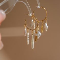 P E A R L ∙ E A R R I N G These beautiful earrings were handmade with love in my studio in Chicago, I designed the "Dreamcatcher" using a variety of uniquely shaped pearls, and each pendant is lovely and unique, blossoming in the ear. * Material: 18K Gold Plated  （Ear pin is partially sterling silver.） * Length: ≈ 2.3" O T H E R ∙ I N F O R M A T I O N * Every order includes elegant, reusable jewelry packaging. Specify in order notes for multiple gift boxes ♡ * If you have any questions or need custom design advice, please feel free to contact us via email; we will respond promptly :) T U R N ∙ A R O U N D ∙ T I M E * Processing Time: 3-7 business days * Delivery Time: 3-10 days worldwide * Free standard shipping. * For precise delivery, please contact us. C A R E ∙ I N S T R U C T I O N S Unique Pearl Jewelry, Baroque Pearls Jewelry, Star Pearl, Unique Hoop Earrings, Ear Pin, Jewelry Girl, Wedding Gifts For Bridesmaids, Shop Jewelry, Design Advice