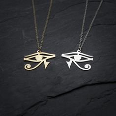 "This beautiful Egyptian Eye of Horus pendant is influenced by the ancient Egyptian culture that considered it as symbol of protection, Comes on a matching gold filled or sterling silver chain and arrives in our signature gift box, ready for gift giving to the lovers in your life. ★ Comes in our signature gift box, ready for gift giving. ★ Available in Silver [Sterling silver chain & silver plated pendant] ★ Available in Gold [18k Gold filled chain & 18k gold plated brass pendant] ★ Pend Gold Plated Evil Eye Symbolic Jewelry, Symbolic Gold Plated Evil Eye Jewelry, Engraved Ankh Jewelry For Gift, Symbolic Pendant Charm Necklaces As Gift, Brass Evil Eye Jewelry As A Gift, Evil Eye Brass Jewelry As A Gift, Amulet Eye Necklace Gift, Brass Evil Eye Jewelry For Gifts, Symbolic Pendant Charm Necklace As Gift