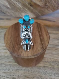 Large Kachina ring in sterling silver and turquoise stones is truly unique! This statement ring is carefully handmade with intricate sterling silver detail work and including concho pieces on the sides and is set off with a lovely turquoise stones. If you love Navajo jewelry, you will love this sterling silver ring. This ring is quite long measuring 2 inches long and sits beautifully on the hand. This statement ring is sure to get you noticed! It would make a lovely anniversary gift or birthday Unique Silver Turquoise Ring With Inlay, Handmade Southwestern Style Ring Jewelry, Handmade Southwestern Style Ring, Southwestern Silver Turquoise Ring For Jewelry Making, Unique Inlay Ring Jewelry, Spiritual Turquoise Ring Jewelry, Unique Turquoise Ring Jewelry, Bohemian Sterling Silver Ring With Inlay, Unique Turquoise Multi-stone Rings