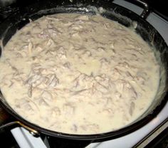 a pan filled with food sitting on top of a stove