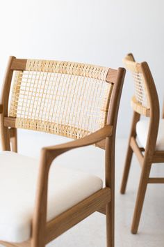 two wooden chairs sitting next to each other