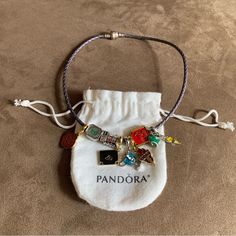 Authentic Pandora Purple Leather Bracelet Wrap Around Wrist Twice / Necklace With 9 Brand New Harry Potter Themed Charms 925 Sterling Silver Clasp & Leather Charms Are All Brand New (Unbranded) Pandora Bracelet Is Authentic. Great Condition. 925 Sterling Silver And Leather Bracelet. Very Pretty Bracelet Set. Perfect For Harry Potter Fan! Please Review All Photos For Details. Beautiful Set! Great Condition. Can Wear As A Bracelet Or Necklace! Total Length Is 15” Harry Potter Pandora Bracelet, Adjustable Silver Bracelet With Logo Charm, Luxury Charm Bracelet With Logo Charm As Gift, Silver Charm Bracelet With Logo For Gift, Silver Charm Bracelet With Logo As Gift, Luxury Logo Charm Bracelet As Gift, Silver Charms Bracelet As Fashion Accessory, Silver Charm Bracelets As Fashion Accessory, Silver Bracelets With Charms As Fashion Accessory