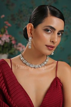 An elegant and classic Polki necklace set is the design that offers delicate hints of traditional legacies and Victorian art form of zirconia setting to bejewel your neckline. Embedded with high-grade Polkis this beauty is designed and handcrafted by artisans of India with traditional jewelry-making techniques. Embellish your appearance with our Polki-inspired necklace that has a resemblance to Bollywood jewelry. Add this charm of Indian Jewelry to your wardrobe and see the heads turn. A perfect Festive Formal Crystal Jewelry Sets, Elegant Kundan Hand-set Necklace For Reception, Dazzling Silver Kundan Necklace With American Diamond, Elegant Hand-set Kundan Necklace For Reception, Elegant Hand Set Kundan Necklace For Reception, Luxury Silver Kundan Necklace For Festive Season, Formal Hand Set Kundan Necklace, Silver Kundan Necklace With Elegant Cubic Zirconia Design, Silver Kundan Necklace With Cubic Zirconia For Celebration