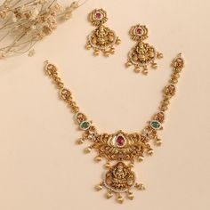 Product Description The Mrinali necklace set is designed in a vintage theme on a shining antique gold base to enhance your poise. The gleaming CZ stones add a highlight to this set making this best to choose for weddings and festivals. Style this set with a saree or layer with other antique necklace sets. Details & Specifications: Materials used: Antique Gold Plated Brass Weight -Necklace: 38 gms, Earrings: 17 gms, Length - Necklace: 13.5 cms, Earrings: 4.5 cms, Make it custom Want to make it a Trending Gold Necklace Designs, Army Wallpapers, Antique Necklace Set, Indian Wedding Jewelry Sets, New Gold Jewellery Designs, Pearl Jewelry Design, Length Necklace, Necklace Sets, Gold Fashion Necklace