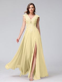 a woman in a long yellow dress with a slited skirt and high slits