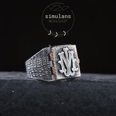 Discover the perfect blend of elegance and personalization with our Sterling Silver Monogram Ring. Expertly crafted from 925 sterling silver, this unique piece features a hinged, square design that opens to reveal a customizable area inside. The exterior is adorned with an intricate bark texture, giving it a distinctive and rugged look. This ring is perfect for engraving initials, monograms, logos, or symbols, making it a thoughtful and personalized gift for any occasion. Whether you're commemor Luxury Silver Initial Ring, Luxury White Gold Initial Ring, Luxury Sterling Silver Signet Ring, Luxury Silver Rectangular Signet Ring, Luxury Silver Initial Ring Hallmarked, Luxury Silver Signet Ring, Luxury Silver Hallmarked Initial Ring, Luxury Engraved White Gold Initial Ring, Luxury Silver Initial Ring With Polished Finish