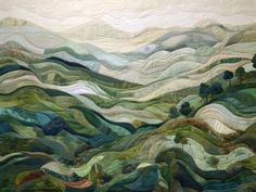 a quilted wall hanging with mountains and trees on it's sides, in the shape of waves