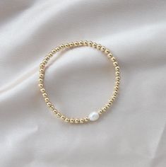 STYLE Wear one or stack a few. DETAILS 4mm 14K Goldfilled Beads 6-6.5 Freshwater Pearl Elastic Stretch Water Resistant Stackable Pearl Bracelet With Round Beads, Stackable Round Bead Pearl Bracelet For Everyday, Elegant Stretch Bracelet With Tiny Beads, Elegant 14k Gold-filled Bracelets With 8mm Beads, Elegant 14k Gold-filled 8mm Beaded Bracelets, Dainty Stackable Pearl Bracelet With Round Beads, Gold Beaded Bracelets, Gold Stretch Bracelet, Pearl Beaded Bracelet