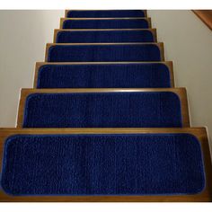 blue carpeted stairs leading up to the top