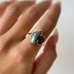 This one-of-a-kind 2 stone ring features a 2.32ct radiant sapphire with reddish-pink hues, set alongside a fiery 3.13ct Australian opal. This ring catches the sun like no other and makes for a stunning statement piece that effortlessly elevates any look. Please note resizing this ring adds an extra 7-10 days for delivery. Fiery Red, Gold Piece, Classic Jewelry, Recycled Gold, Australian Opal, Stone Ring, Pink Sapphire, Stone Rings, Custom Jewelry