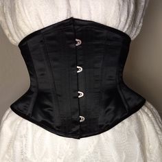 A Black Satin Corset With 100% Steel Boning, Busk Closure And Black Lacing Ribbon In The Back. A Cincher Length At 9" From Top To Bottom With High Hips And Conical Shaped Rib. Several Sizes Are Available And Note That The Size Listed Will Be The Total Inch Measurement When The Corset Is Closed. All Are New Without Tags! Wedding Black Fitted Corset Belt, Elegant Black Corset For Wedding, Elegant Black Wedding Corset, Elegant Black Corset Belt With Boned Bodice, Elegant Underbust Corset Belt, Elegant Wedding Corset Belt With Boning, Elegant Black Overbust Corset, Formal Black Corset With Boning, Black Satin Corset For Formal Occasions