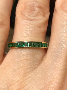 A beautiful channel set princess cut emerald green half eternity ring set in 14K yellow gold / 925 sterling silver. A perfect wedding band, stacking band or simply, wear alone. The emeralds are lab created and match perfectly to grade AAA natural emeralds in color. Width: 3mm Green Stackable Eternity Band For Anniversary, Green Eternity Band For Anniversary With May Birthstone, Classic Green Stackable Eternity Band, Green Prong-set Eternity Band For Anniversary, Green Eternity Band With Prong Setting For Anniversary, Fine Jewelry Stackable Eternity Band For Anniversary, Classic Green Eternity Promise Ring, Emerald Cut Eternity Band For Anniversary, Green Half Eternity Stackable Rings For Anniversary