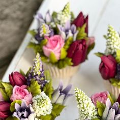 small cupcakes with flowers and greenery in them