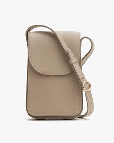 Small vertically oriented shoulder bag with strap and front flap closure. Classic Crossbody Phone Bag For On-the-go, Versatile Phone Bag With Cell Phone Pocket For On-the-go, Modern Pouch Phone Bag For On-the-go, Classic Phone Bag Pouch For On-the-go, Chic Leather Phone Bag For Everyday Use, Modern Phone Bag Pouch For On-the-go, Leather Phone Bag With Removable Pouch For On-the-go, Chic Leather Phone Bag With Removable Pouch, Modern Phone Bag With Removable Pouch For Daily Use